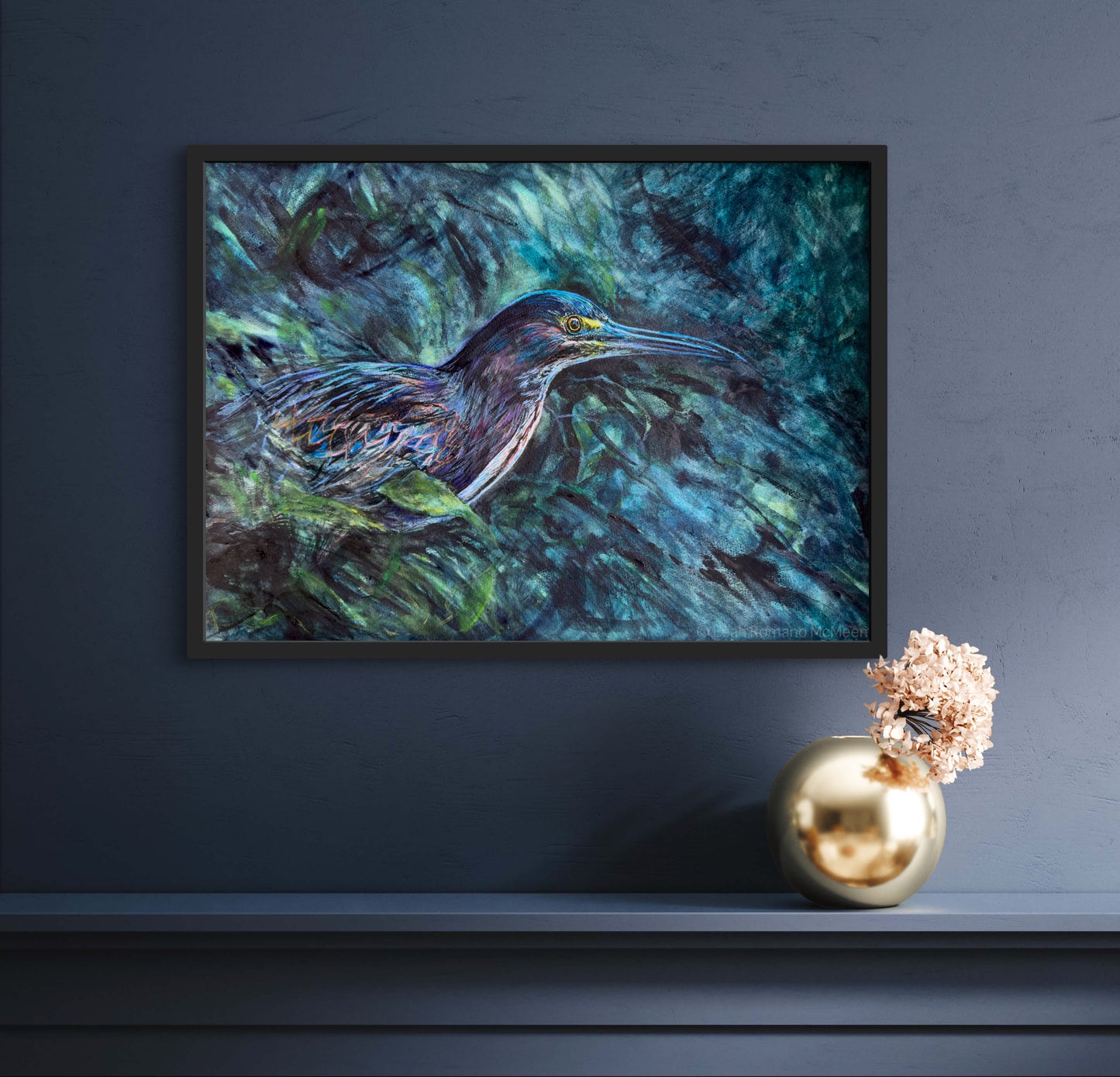 Framed painting of a bird in a natural setting on a dark blue wall with decorative elements.