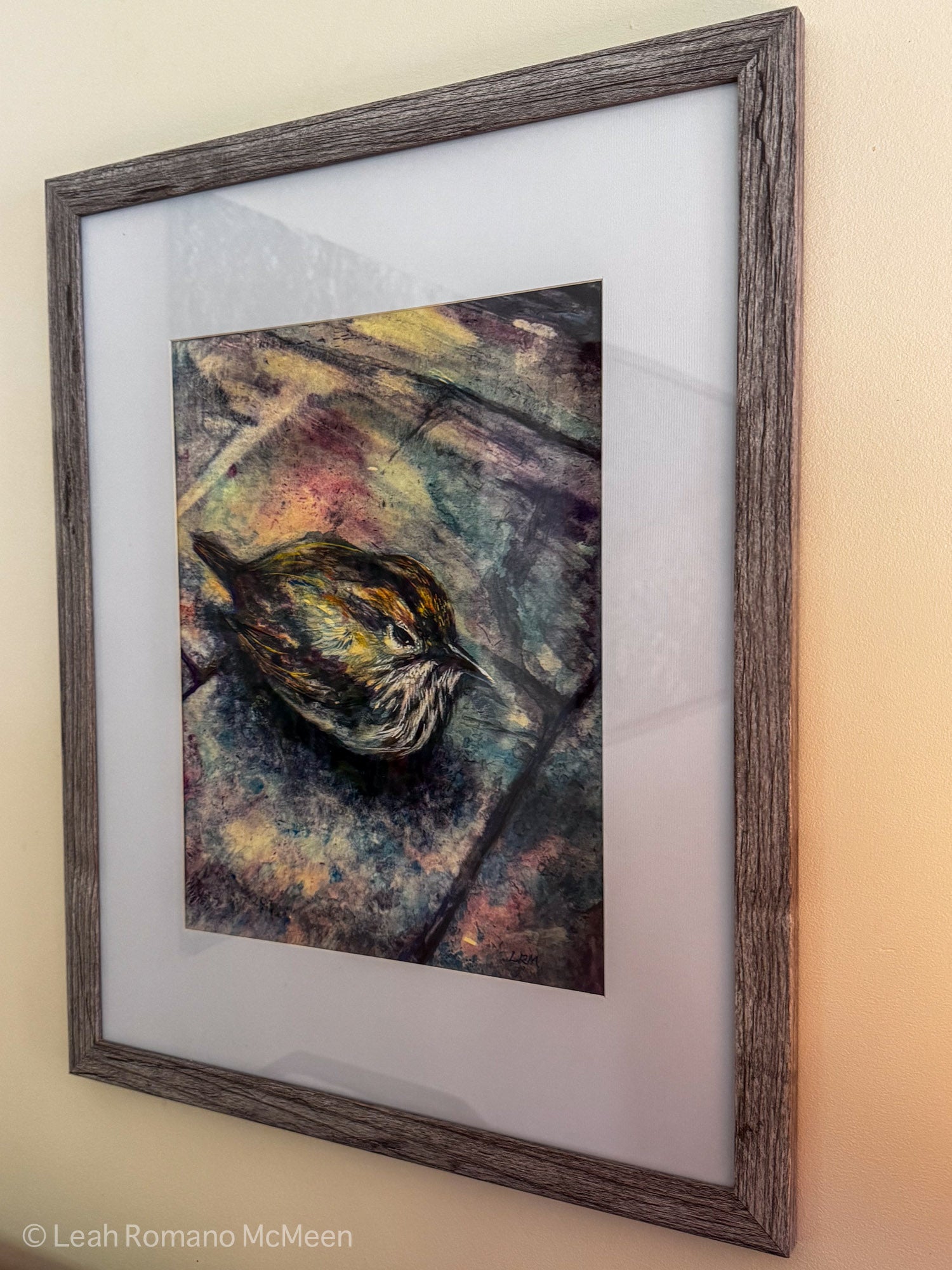 Framed artwork of a bird on a textured background