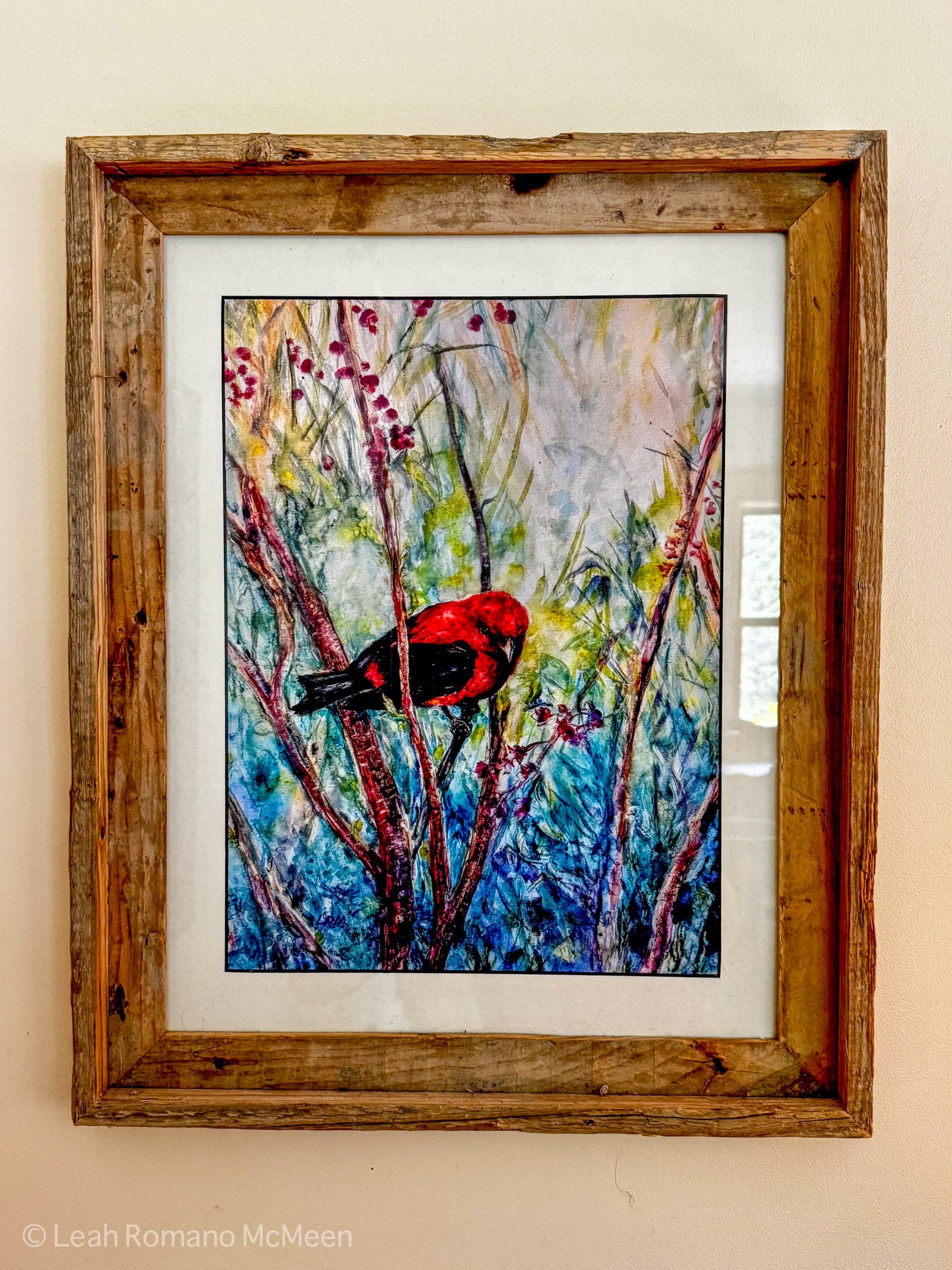 Framed artwork of a bird on a branch with a wooden frame.